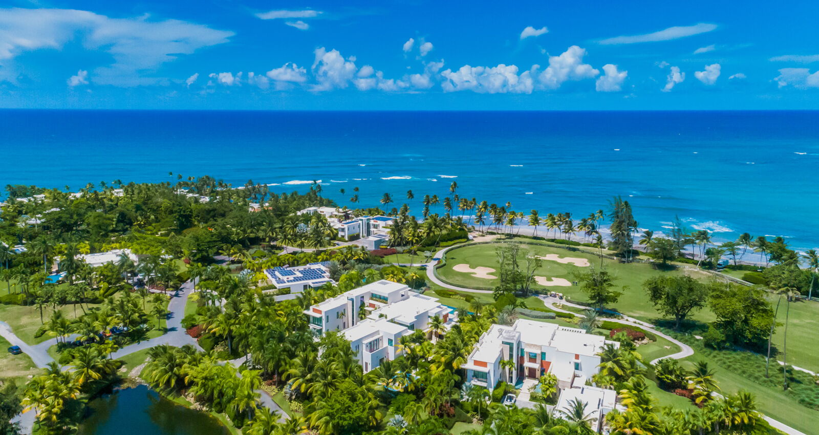 aerial view of ocean front estates at dorado beach showcasing the golf course and ocean
